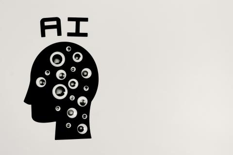 A head silhouette with eyes on it and ai written above it 